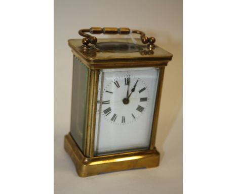 A SMALL BRASS CASED DUVERDREY &amp; BLOQUEL CARRIAGE CLOCK, the enamel dial with Roman numerals, the movement with lion backs