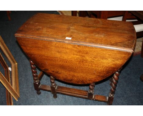 AN OAK BARLEY TWIST DROPLEAF TABLE