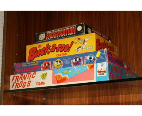 FOUR VINTAGE BOARD GAMES COMPRISING OF A TRI-ANG FRANTIC FROGS GAME, VINTAGE BUCKAROO, FRUSTRATION AND THE WALL WALKERS (4) 