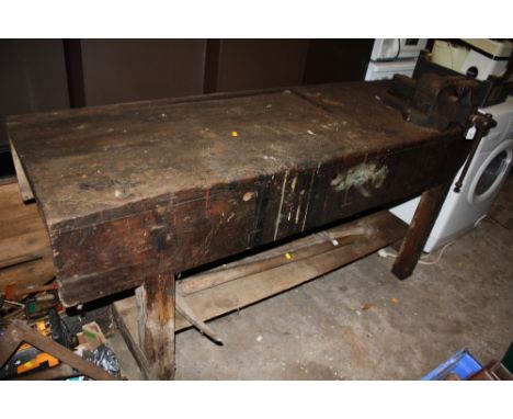 A LARGE VINTAGE WORKBENCH WITH MOUNTED VICE