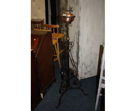 AN ANTIQUE IRON AND COPPER LAMP STANDARD