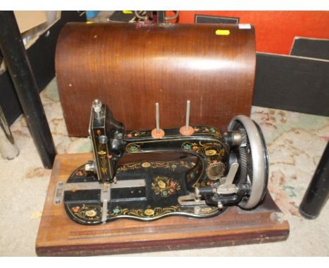 A VINTAGE CASED SEWING MACHINE 