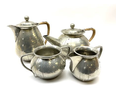 Four piece pewter tea set, comprising teapot, coffee pot, milk jug and a twin handled sucrier, with planished finish and wove