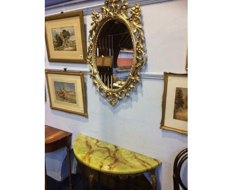 A gilt oval mirror and console table