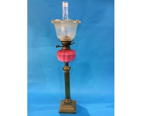 A Victorian oil lamp with pink reservoir and frosted shade 'Youngs'.  84 cm high
