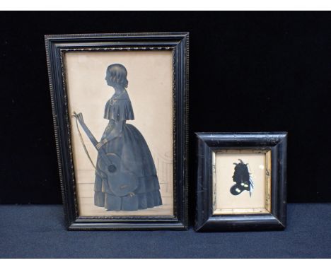 A MID 19th CENTURY FULL-LENGTH SILHOUETTEa lady holding a guitar, framed 26 x 17cm, and a smaller silhouette portrait (2)