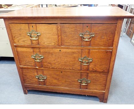 AN OAK CHEST OF DRAWERS BY HARRIS LEBUS, LONDONwith patent 8896-104 panelled drawers, the locks stamped 'HLL', 99cm wide (one