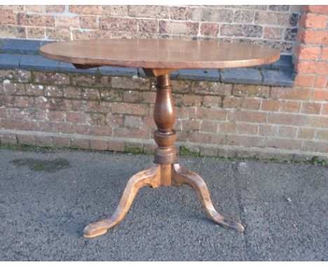 A 19th CENTURY OAK TRIPOD TABLEwith tip-up top 84cm dia (repaired)