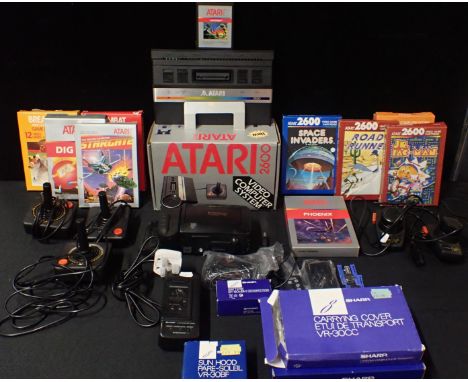 A VINTAGE ATARI 2600 'VIDEO COMPUTER SYSTEM'no. S.N x70830411956, boxed, with games including JR. PAC-MAN, SPACE INVADERS, ST