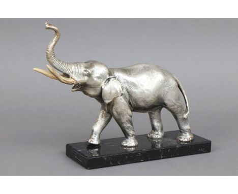   ElefantenfigurMetallguss, versilbert, wohl um 1930, stehende Darstellung mit emporgestrecktem R  ElefantenfigurMetallguss, 