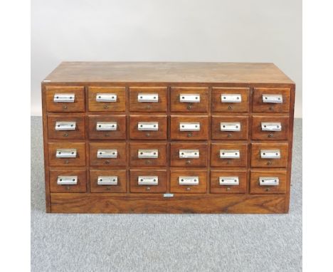 A mid 20th century light oak flight of twenty-four drawers, 98cm
