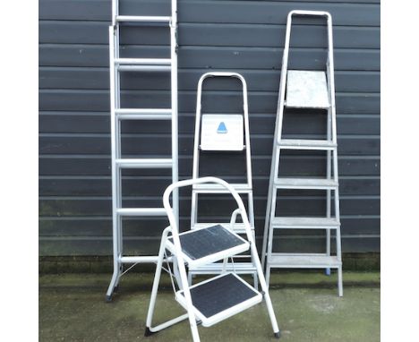 An aluminium ladder, together with two stepladders and a folding step