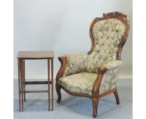 A Victorian style walnut tapestry upholstered spoon back arm chair, together with a nest of two occasional tables, 43cm