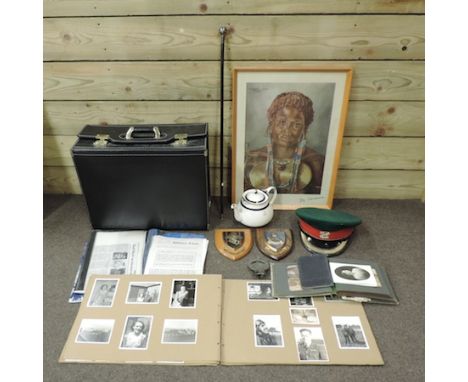 A collection of military related ephemera to include a hat, swagger stick, commemorative china and an African print