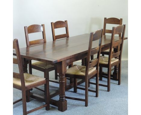 A stained oak refectory table, 204 x 90cm together with a set of six rush seated ladder back dining chairs 