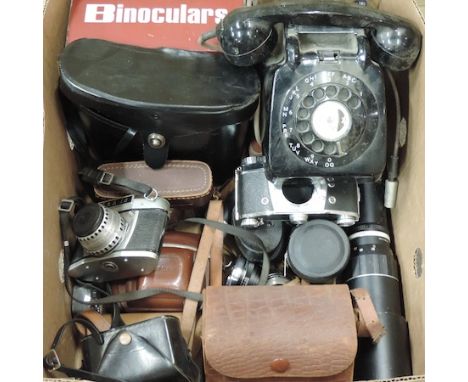 A box of vintage cameras and binoculars