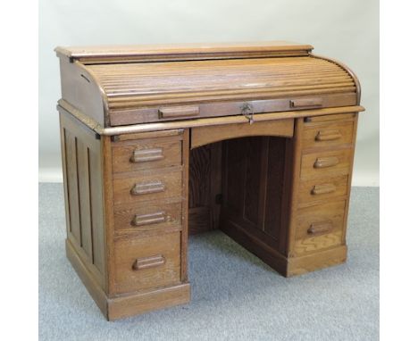 A 1930's light oak tambour front pedestal desk, 122cm