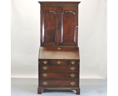 An 18th century style oak bureau cabinet, on bracket feet, 93cm