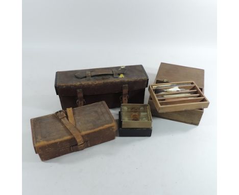 A collection of early 20th century microscope slides, together with tools and boxes