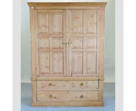 A Victorian pine double wardrobe, with drawers below, 143cm, together with a pine wall mirror