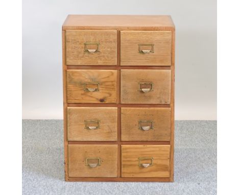 A mid 20th century light oak flight of eight drawers, 51cm