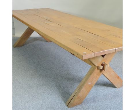 A light oak refectory table, of large proportions, with a plank top, on an x-frame base, 300 x 94cm