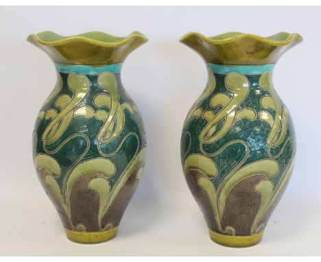 Pair of Burmantofts art pottery vases of baluster form with lobed flared rims and scrolling sgraffito with glazes in turquois