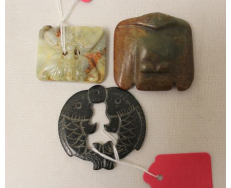 Three Chinese archaic and archaised jade carvings comprising; a dark jade pierced disc of two carp, 6cm wide, a square toggle