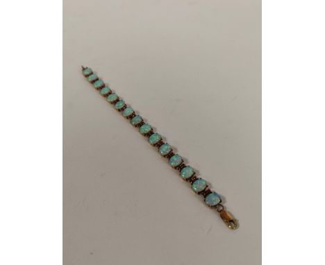 Gold bracelet with oval opals separated by rubies, probably 9ct, 10g.Condition:Condition good - no issues.17cm long. One piec