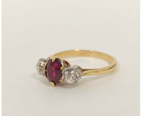 Diamond and ruby three stone ring with with oval ruby, approx. 6mm x 5mm and two old cut brilliants each approx. .3ct in gold