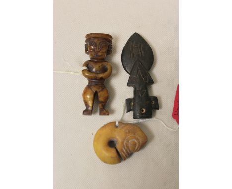 Three pieces of Chinese archaic and archaised carved jade comprising; a dark jade carving of spearhead form, 8.5cm long, an a