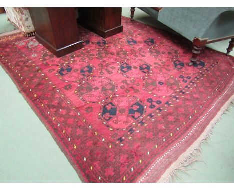 A large 20th Century Eastern red ground wool carpet