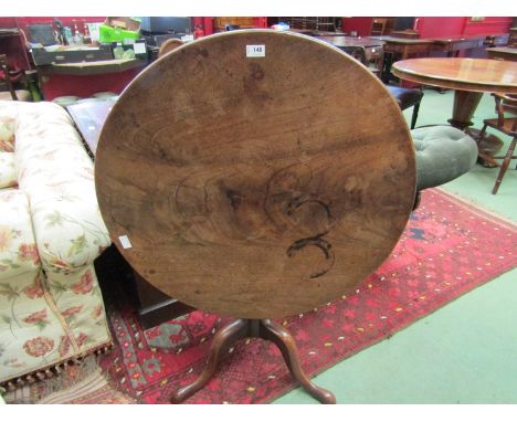 A George III mahogany tilt top wine table on turned column to tripod base