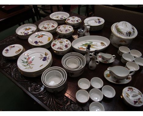 A large collection of Royal Worcester "Evesham" pattern dinner wares including casserole dishes, tureens, cruets, plates and 