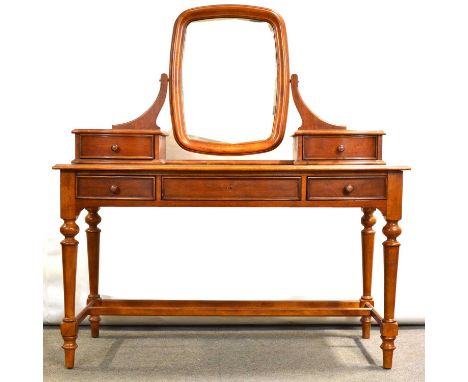 Cherry wood dressing table, with mirror back above trinket drawers, bowfront with three drawers, turned legs, width 132cm, de