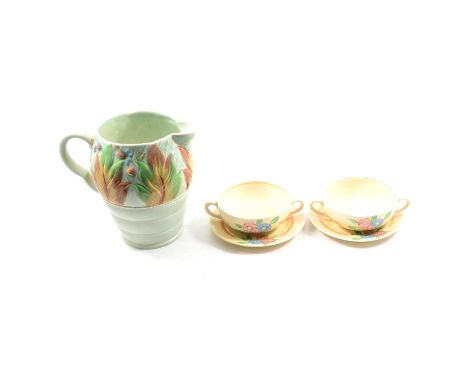 A Clarice Cliff Newport Pottery Celtic Leaf and Berry jug, 19cm; and two twin-handled soup bowls with saucers, floral design.