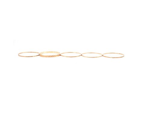 Five 9 carat yellow gold bangles, four 9 carat yellow gold 2.5mm gauge bangles, import marks for London 1970, various bright 
