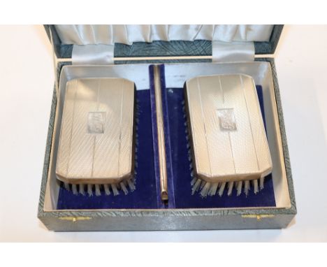 A pair of cased silver gentleman's brushes and a silver mounted faux tortoiseshell comb