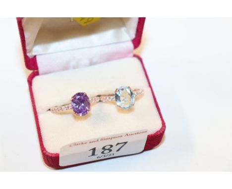 A rose sterling silver and amethyst CZ ring, size QR, and a blue topaz and CZ ring, size LM