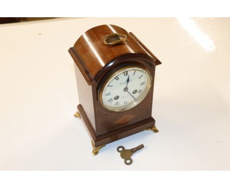 A Finnigans Limited of Manchester inlaid mahogany mantel clock
