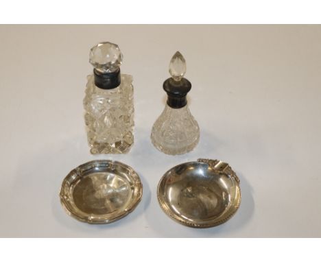 A cut glass and silver mounted scent bottle, another scent bottle and two white metal pin dishes