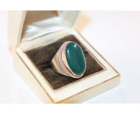 A large Chinese silver and green hardstone set ring, size PQ, 8.8g