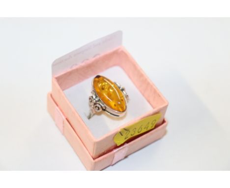 A large sterling silver and amber ring, size O