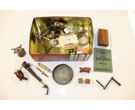 A tin containing travelling cribbage board, pipes, retro alarm clock etc