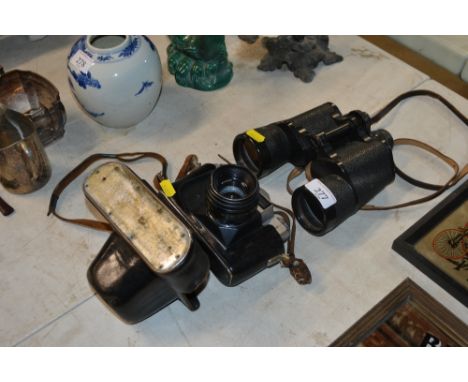 A pair of Carl Zeiss 7 x 50 binoculars and a Zenit camera