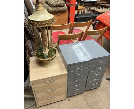 A pair of grey painted filing drawers together with another cabinet and a lamp