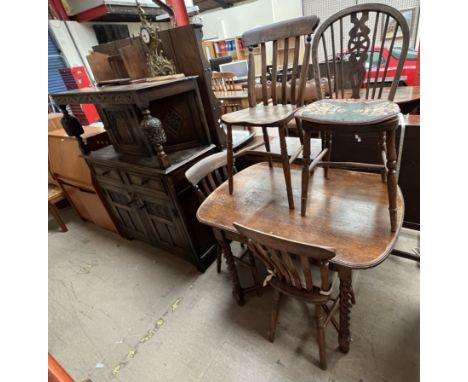 A 20th century oak court cupboard together with an oak dining table, four kitchen chairs, book rest and a brass mantle clock