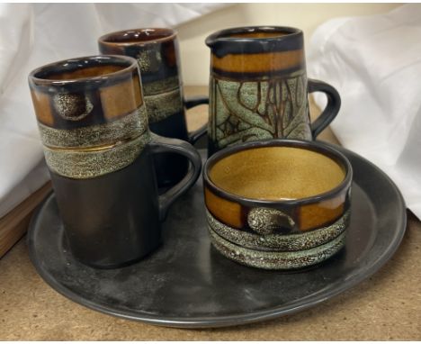 A pottery part coffee set comprising two coffee cups, cream jug, sugar basin and tray 