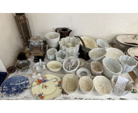 A collection of pottery jelly moulds, various sizes together with a robot, brass fire irons and assorted plates 