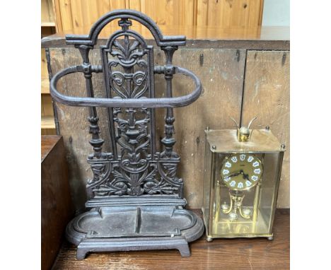 A cast iron stick stand together with an Acctim brass anniversary clock